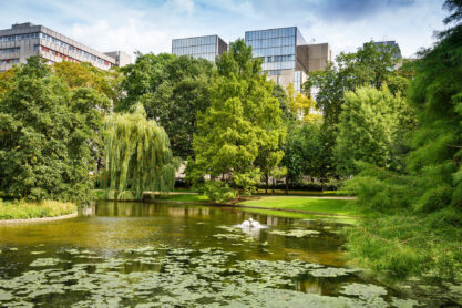 Leopold park with pond, trees and buildings in Brussels, Belgium.