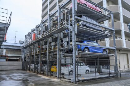Vertical parking in Japan - November, 27, 019 Multi-level vertical lift parking lot three stories high by an apartment building in Japan