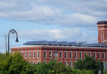 Solar panels installed on the roof of old brick building