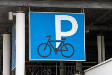 Blue and white sign above the entrance of a bicycle parking garage