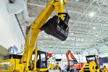 Close up of excavator in exhibition hall.