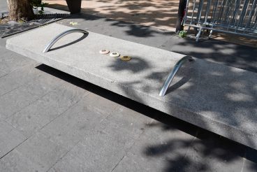 Hostile architecture defensive bench with metal armrests designed to stop people laying down sitting in street france Antibes city french