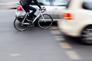 cyclist in city traffic in motion blur