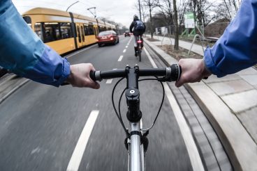 First-person view of cyclist in the city at morning