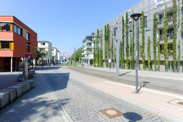 Freiburg im Breisgau, September 4, 2021: The young Vauban district stands for the green and ecologically exemplary Freiburg. The tram runs every seven minutes during the day, there are three stops in the quarter. In fact, as planned, cars are rarely on the roads here. There is a lot of green: where the tram goes, between the buildings and on all the balconies.