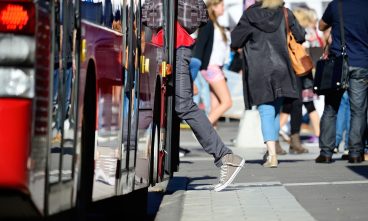 Person enters bus